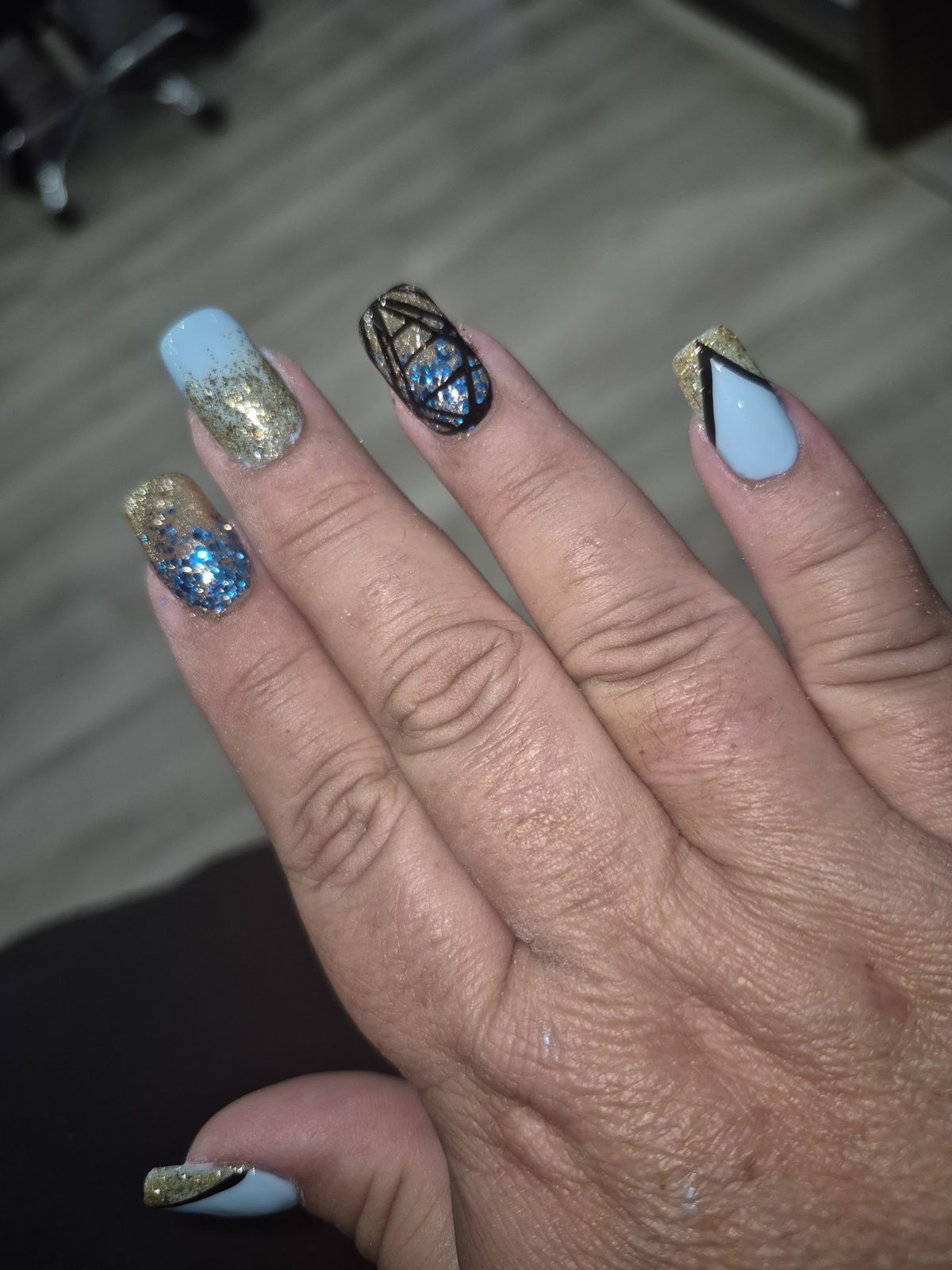 Gold glitter and blue geometric nail art