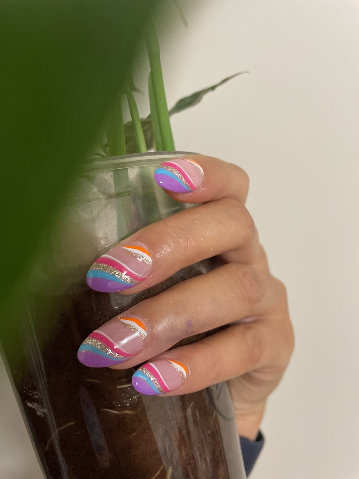 Rainbow striped French tips with gold glitter